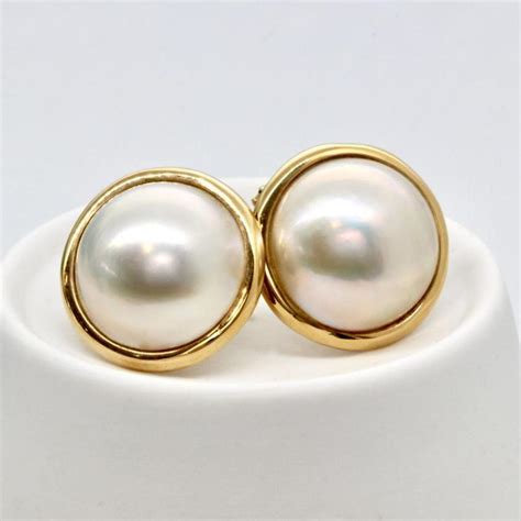 pearl earrings with gold surround.